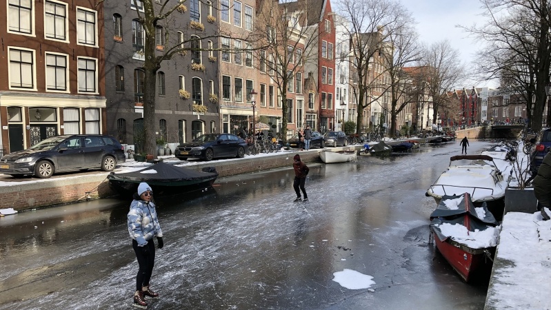 Winter in Amsterdam skating on canals