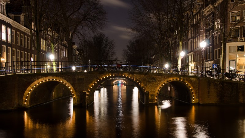 amsterdam canal cruise tour during night bridge
